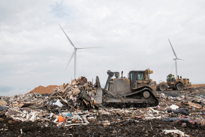 A bulldozer pushing piles of waste at the Frey Farm Landfill