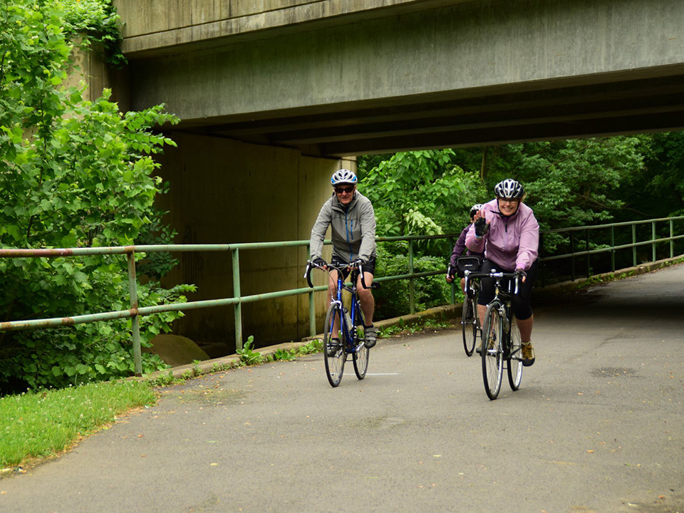 A couple riding their bikes on a trail 